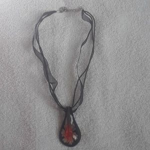 Glass orange hibiscus flower necklace.